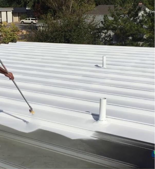 White corrugated metal roof being cleaned with pressure washer wand