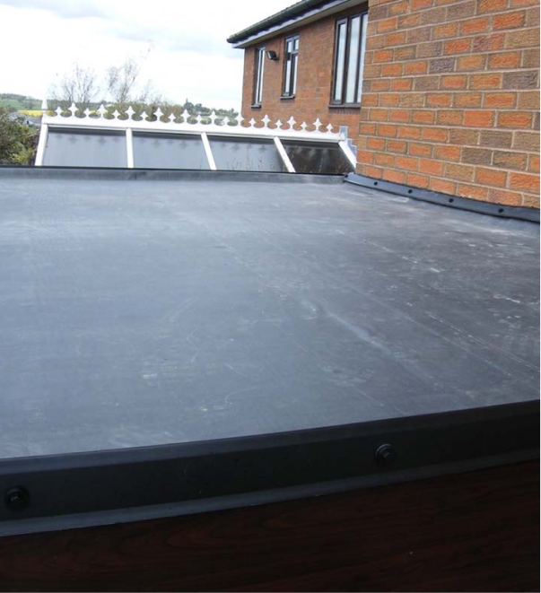 Flat roof with EPDM rubber membrane on residential brick house extension