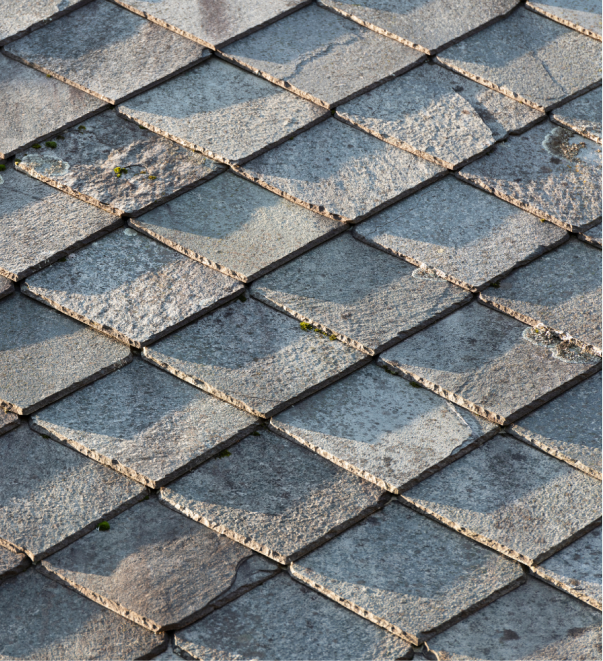 Weathered stone cobblestone pavement with diamond pattern and moss growth