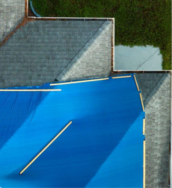 Aerial view of blue swimming pool with lane markers and concrete deck