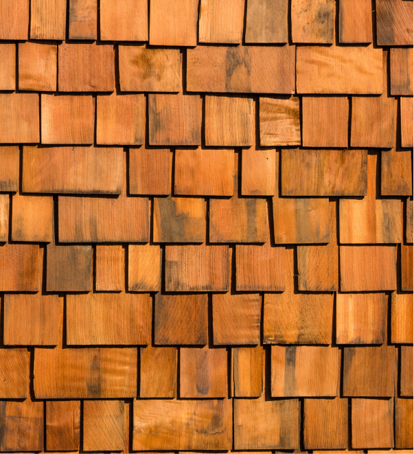 Natural cedar wood shingle siding texture with warm brown tones and weathered finish