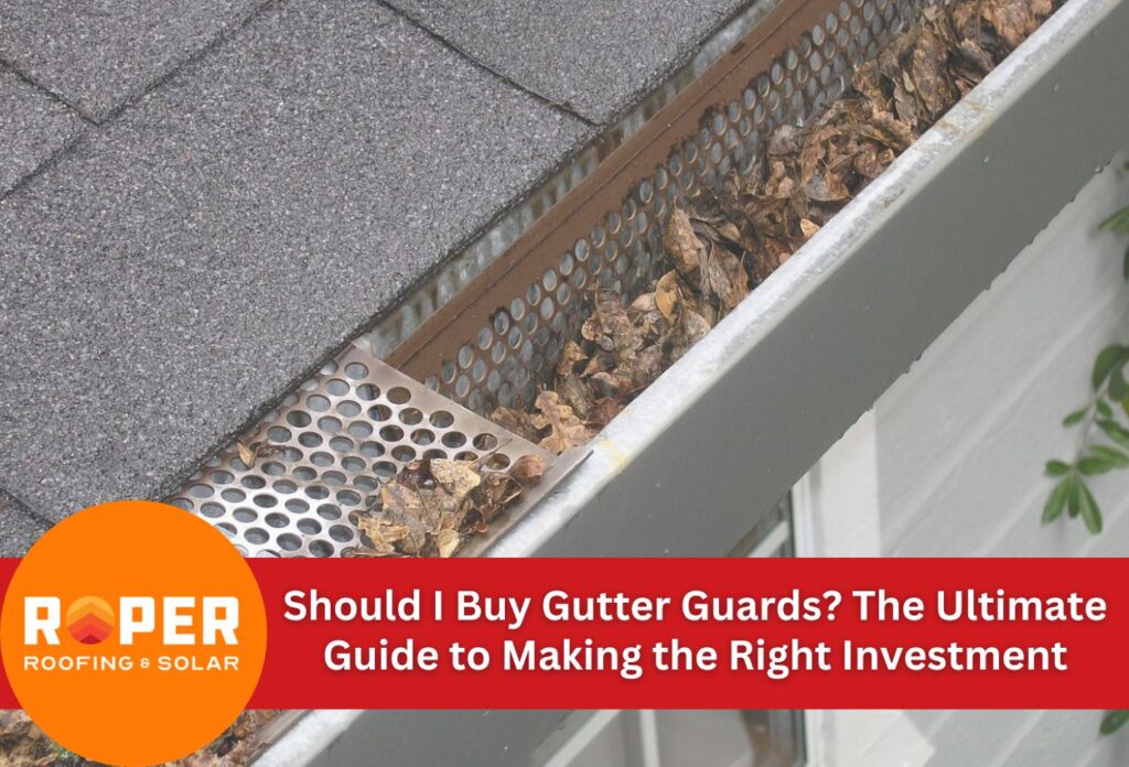 Gutter with perforated metal guard covering filled with autumn leaves, showing roof shingles and white gutter system