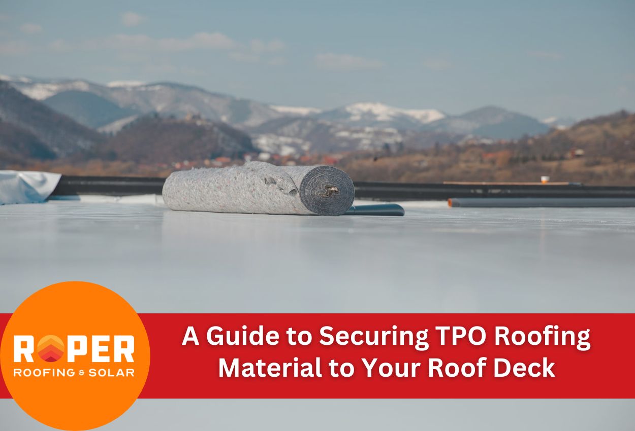TPO roofing material roll on roof deck with mountains in background