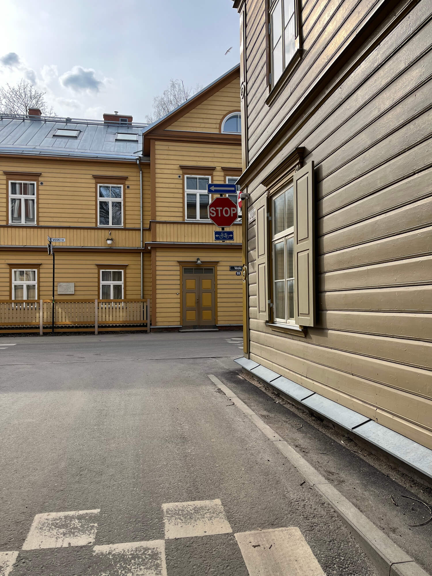 Historic wooden buildings in European old town street with stop sign and traditional architecture