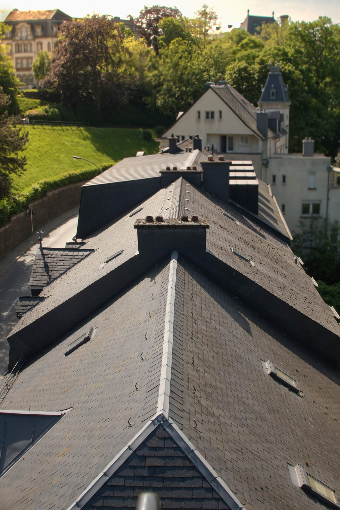 Aerial view of residential rooftops with shingle tiles in suburban neighborhood
