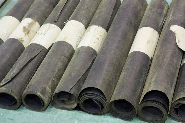 rolls of black roofing material 