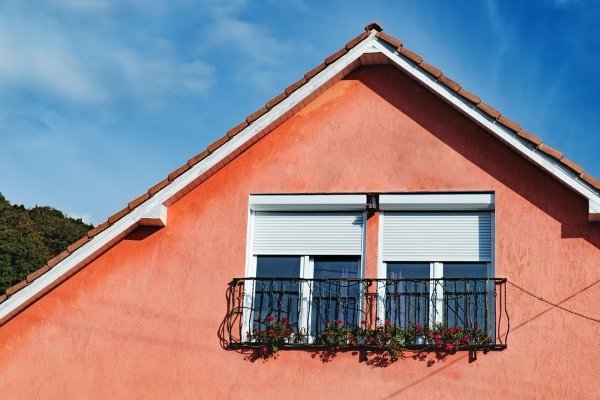 red orange stone house with balcony