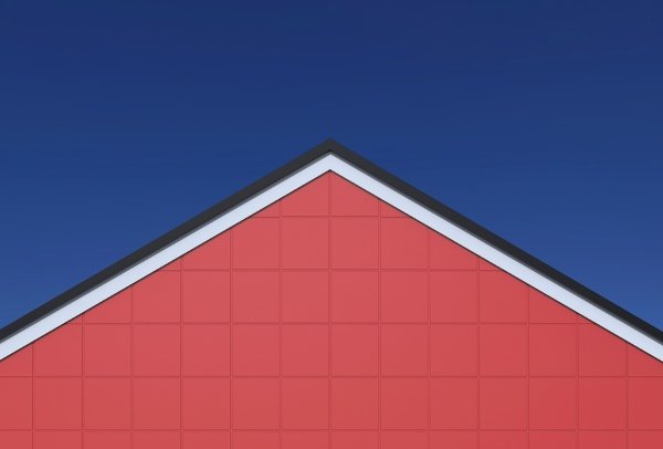 gable roof of red house against blue background