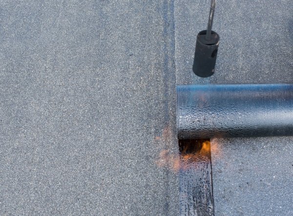 blowtorch on modern flat roof materials